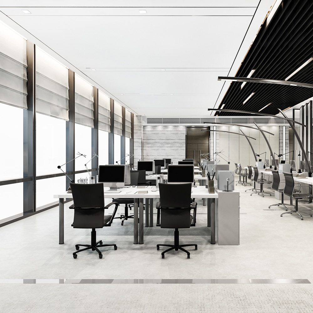 Open plan office with rows of desks, monitors and empty chairs, the corporate estate a UAE group runs across its subsidiaries