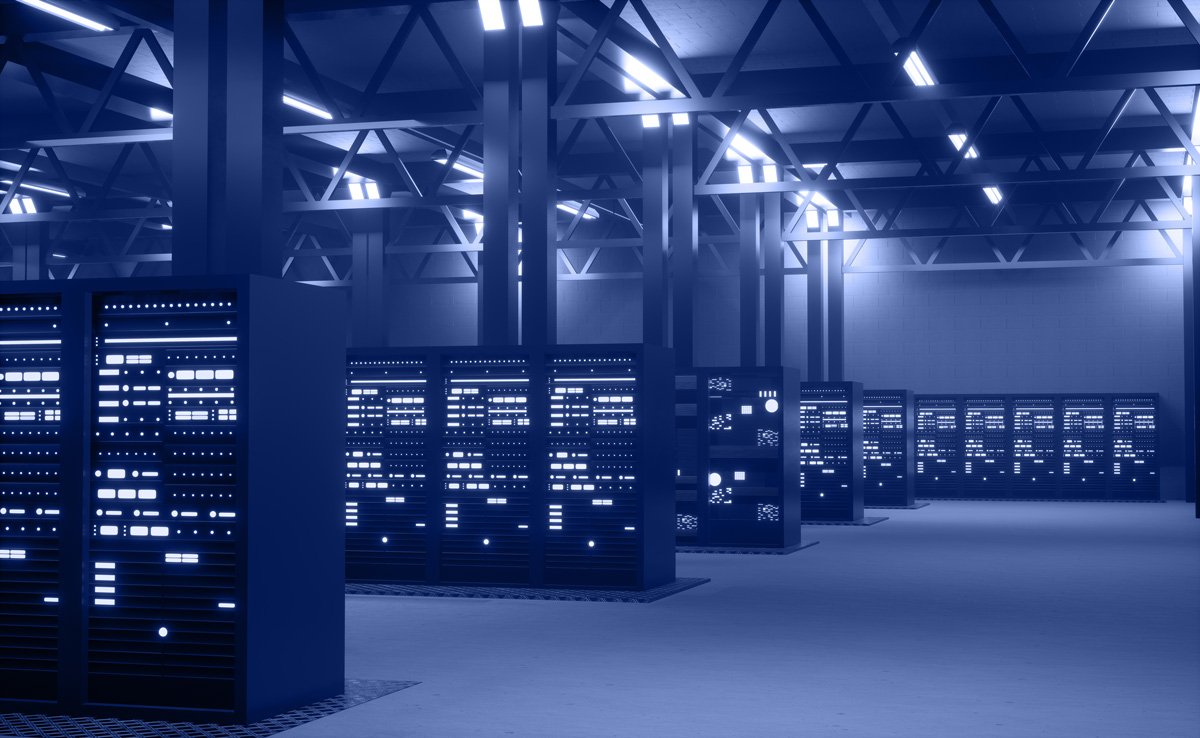 Server cabinets with status lights in a large data hall, the environment a NOC keeps running